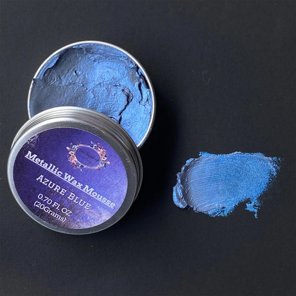 Metallic wax mousse container with blue wax on a black background