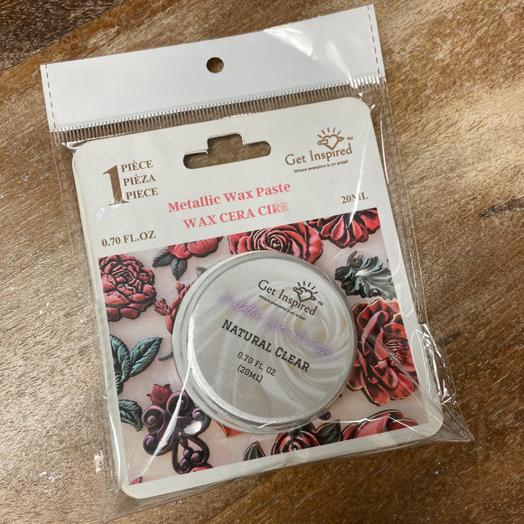 Packaged metallic wax paste with floral design on a wooden surface