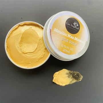 Gold wax mouse with open lid on a dark background