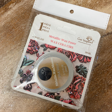 Packaged wax paste with floral design on a wooden surface
