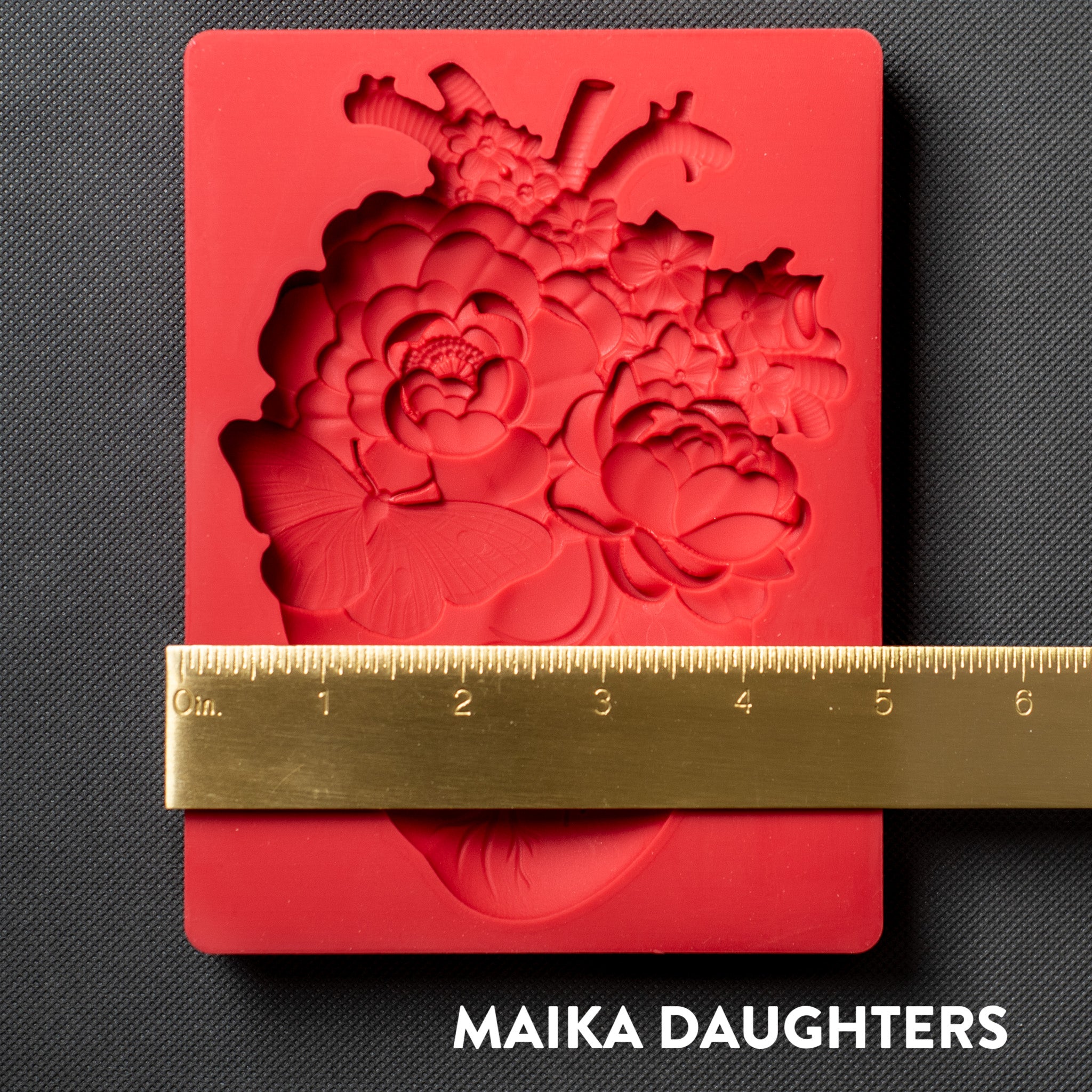 A red silicone mold of Get Inspired by Dadarkar Art's Blooming Heart is against a dark grey background. A gold ruler reading 5" width is on the mold.