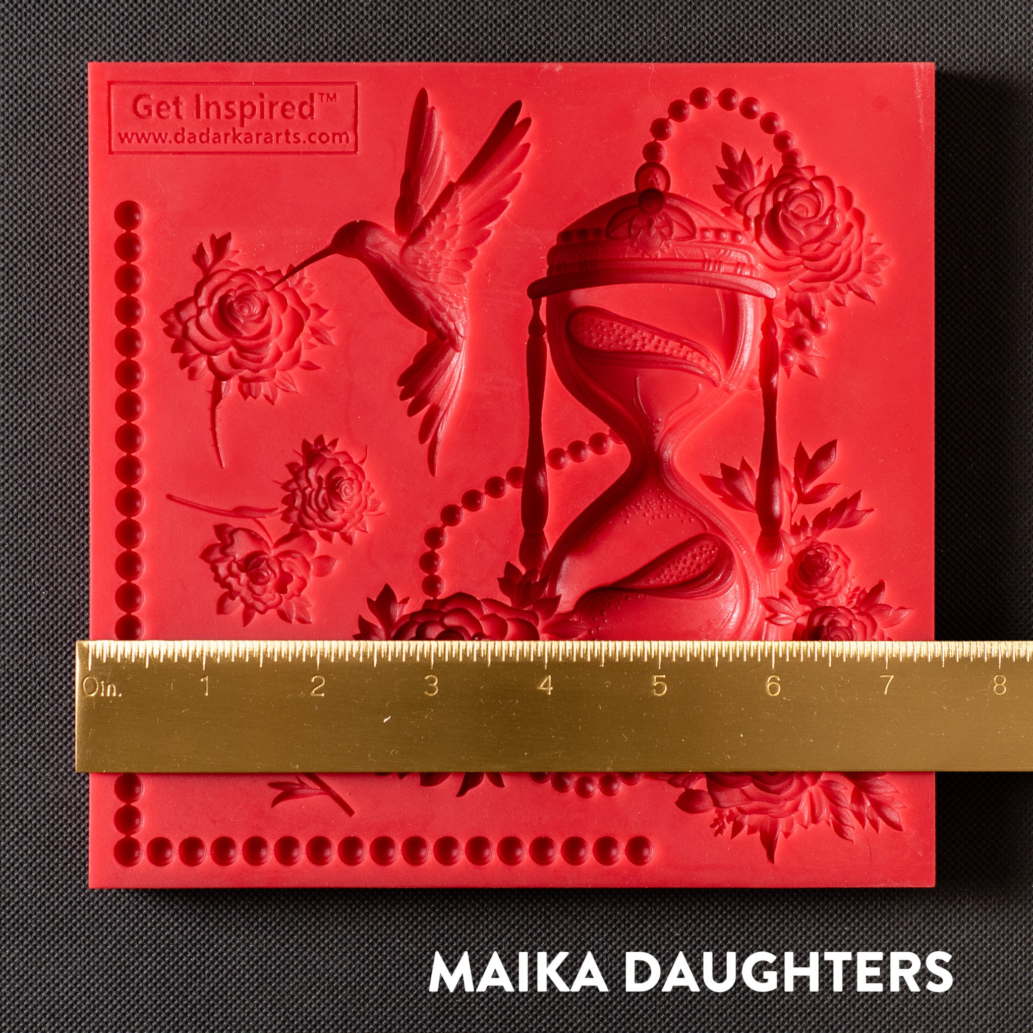 A red silicone mold of Get Inspired by Dadarkar Art's Time Is Flying is against a dark grey background. A gold ruler reading 7.5 inches width sits on the mold.