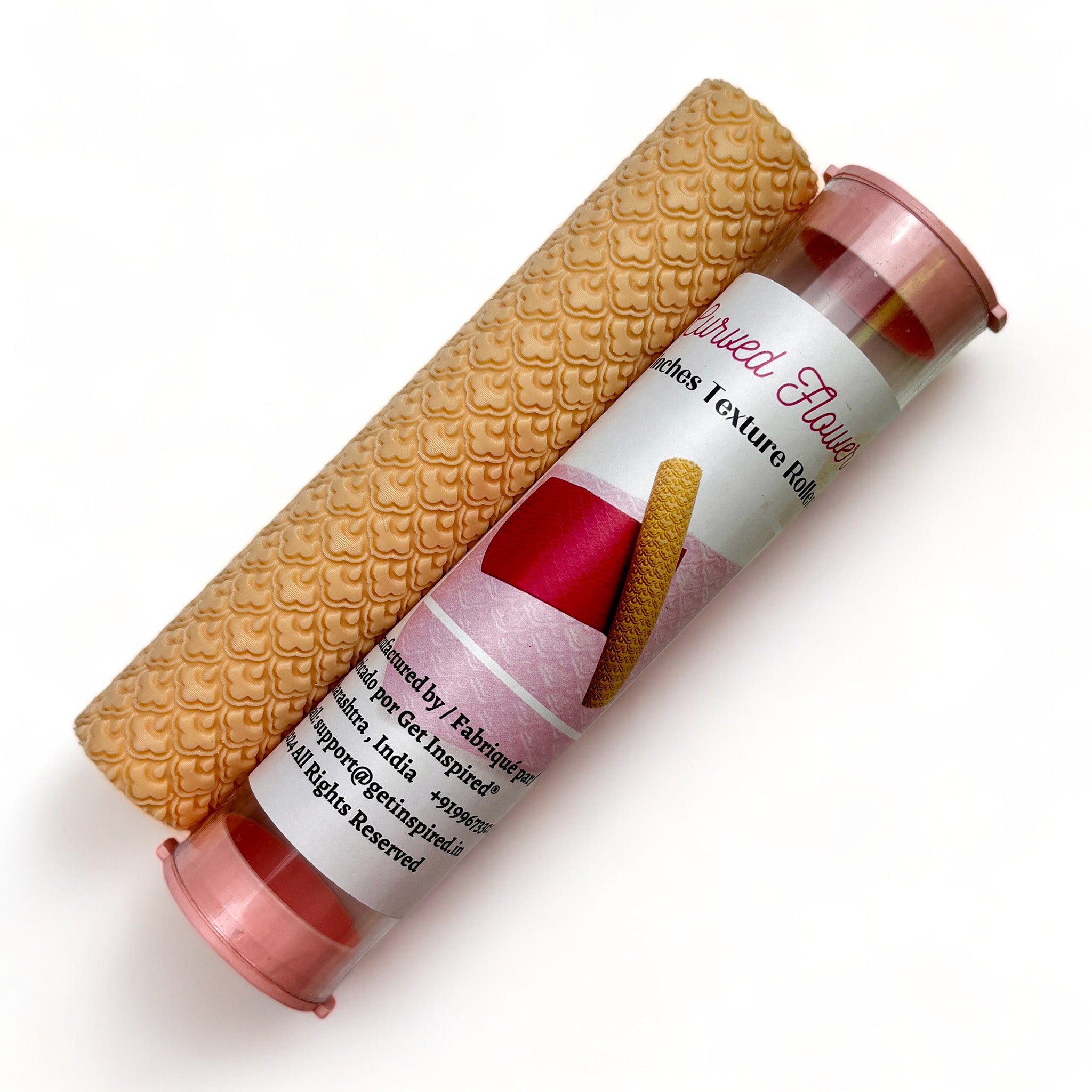 A texture roller and packaging tube of Dadarkar Art's Curved Flowers are against a white background.
