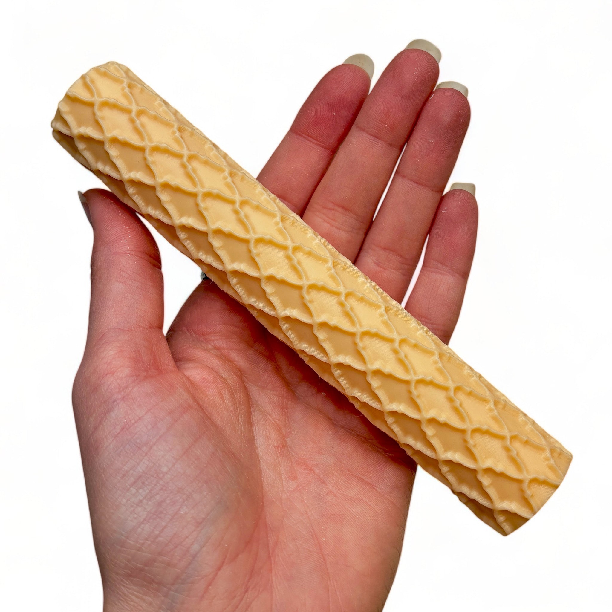 A hand is shown holding Dadakar Art's Moroccan Pattern Texture Roller against a white background.
