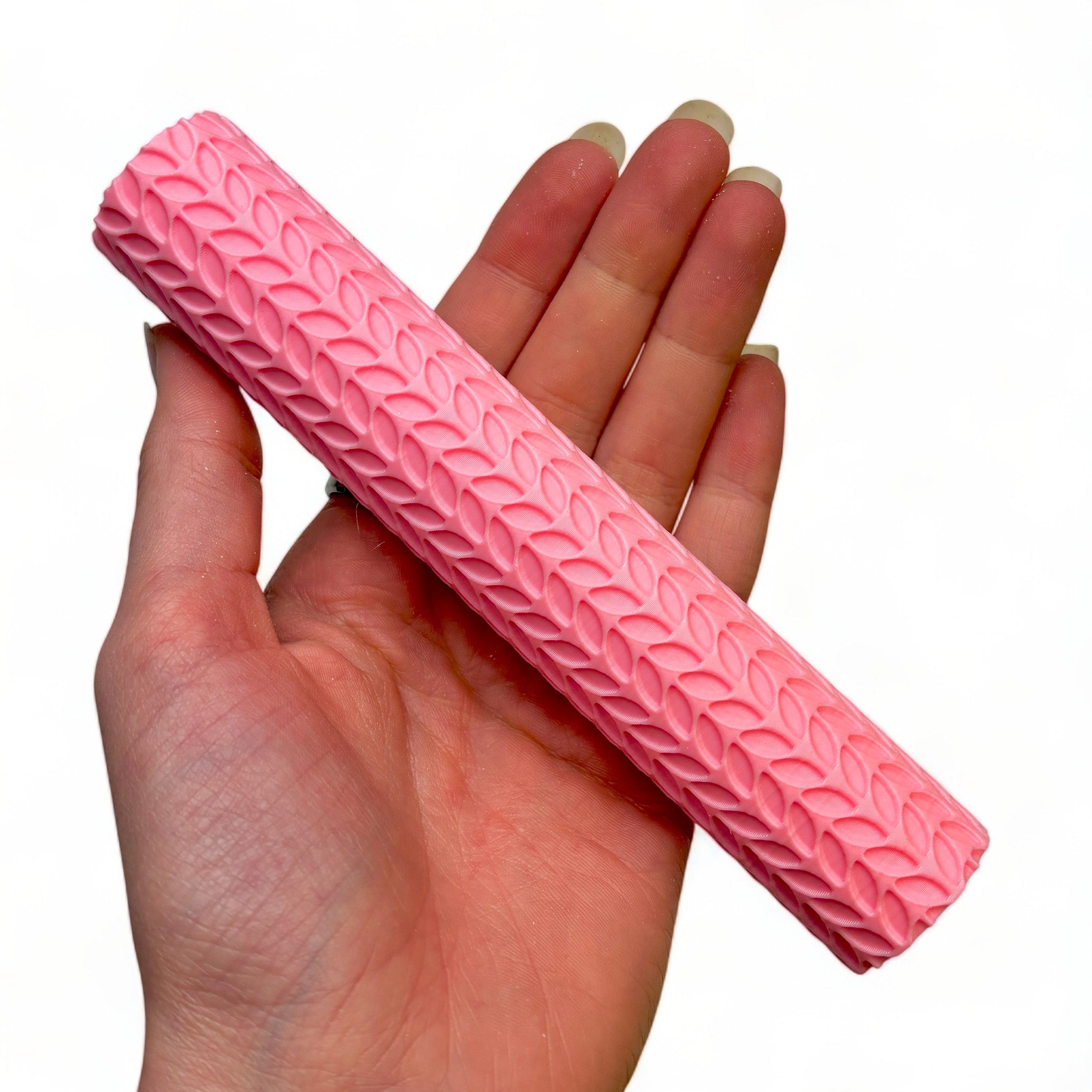 A hand is shown holding Dadakar Art's Palm Leaf Texture Roller against a white background.
