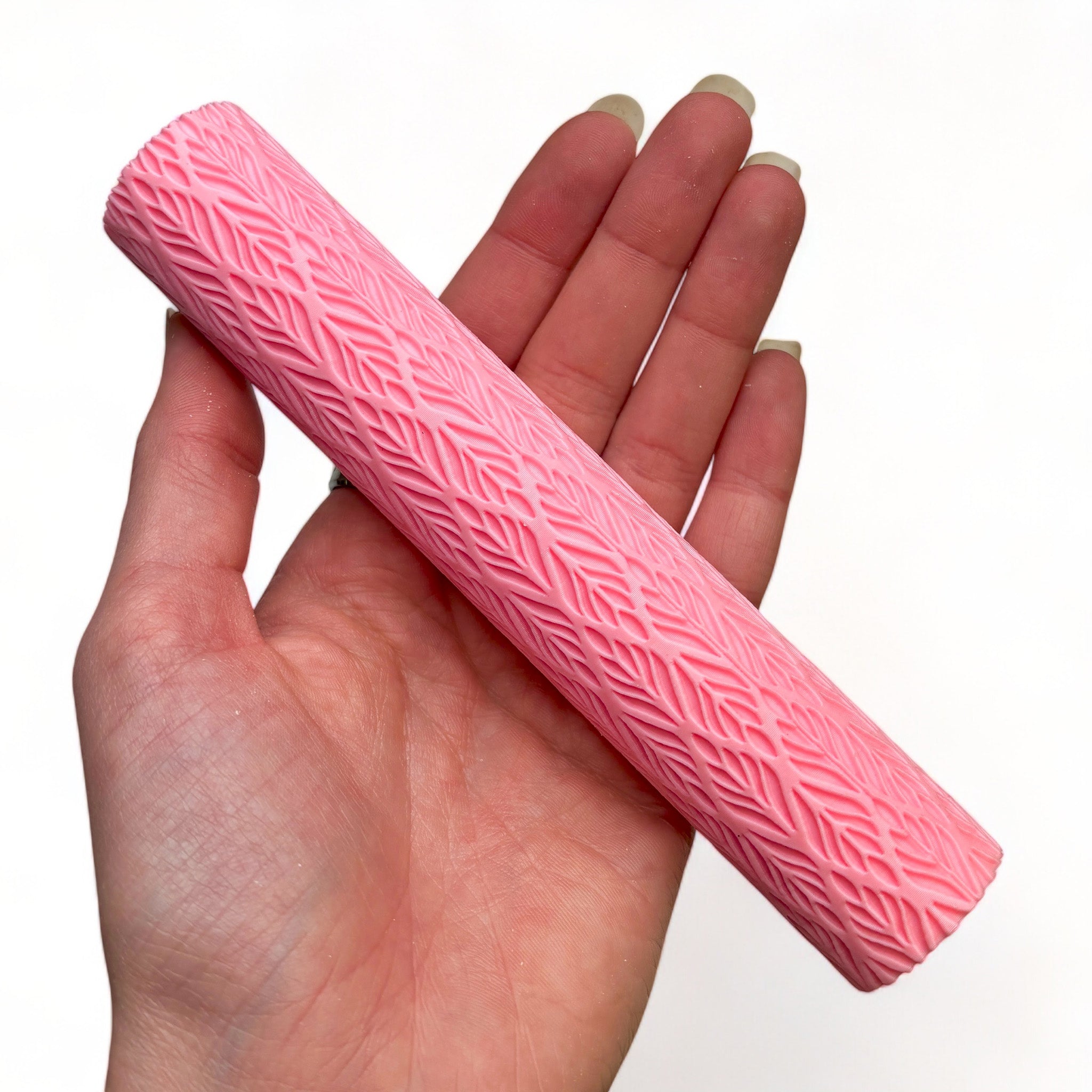 A hand is shown holding Dadakar Art's Venetian Leaf Texture Roller against a white background.
