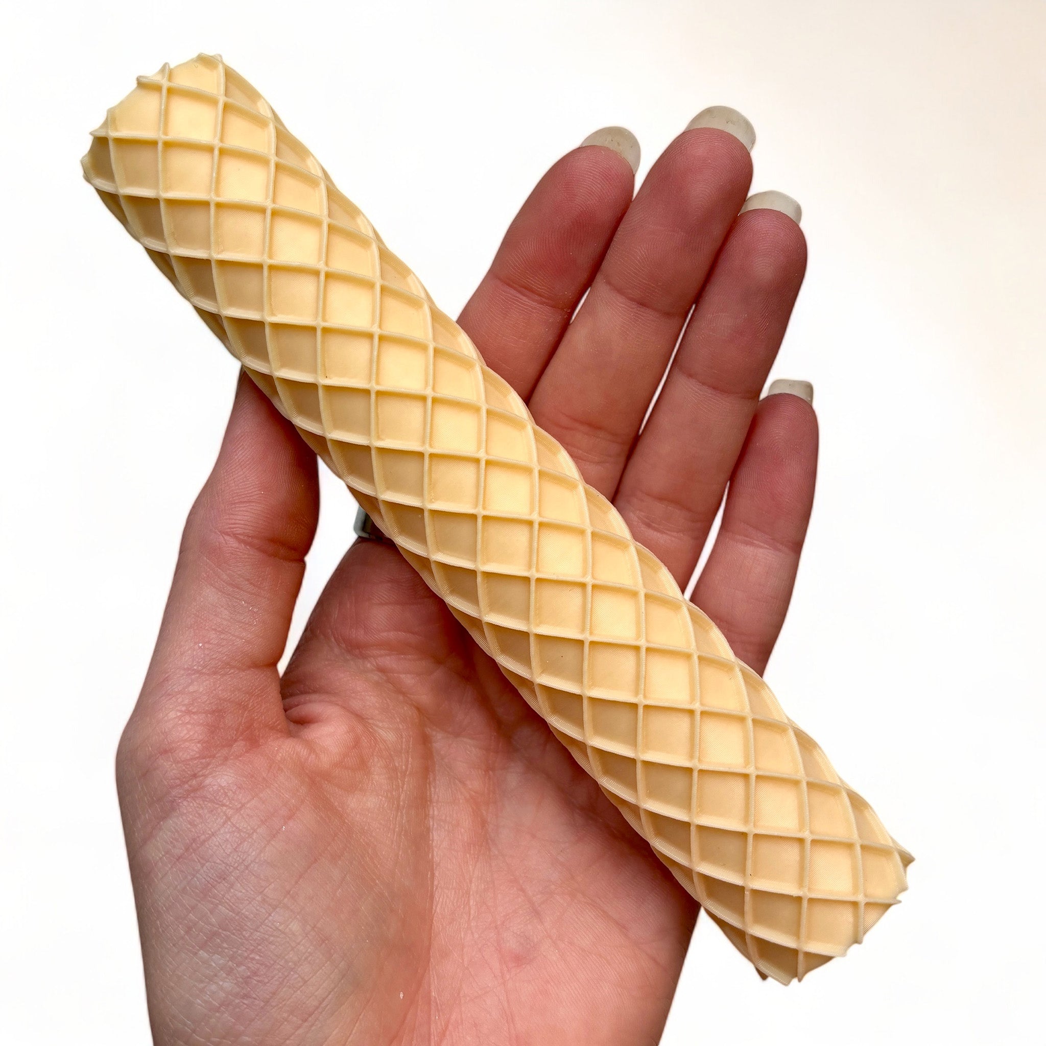 A hand is shown holding Dadakar Art's Waffle Pattern Texture Roller against a white background.
