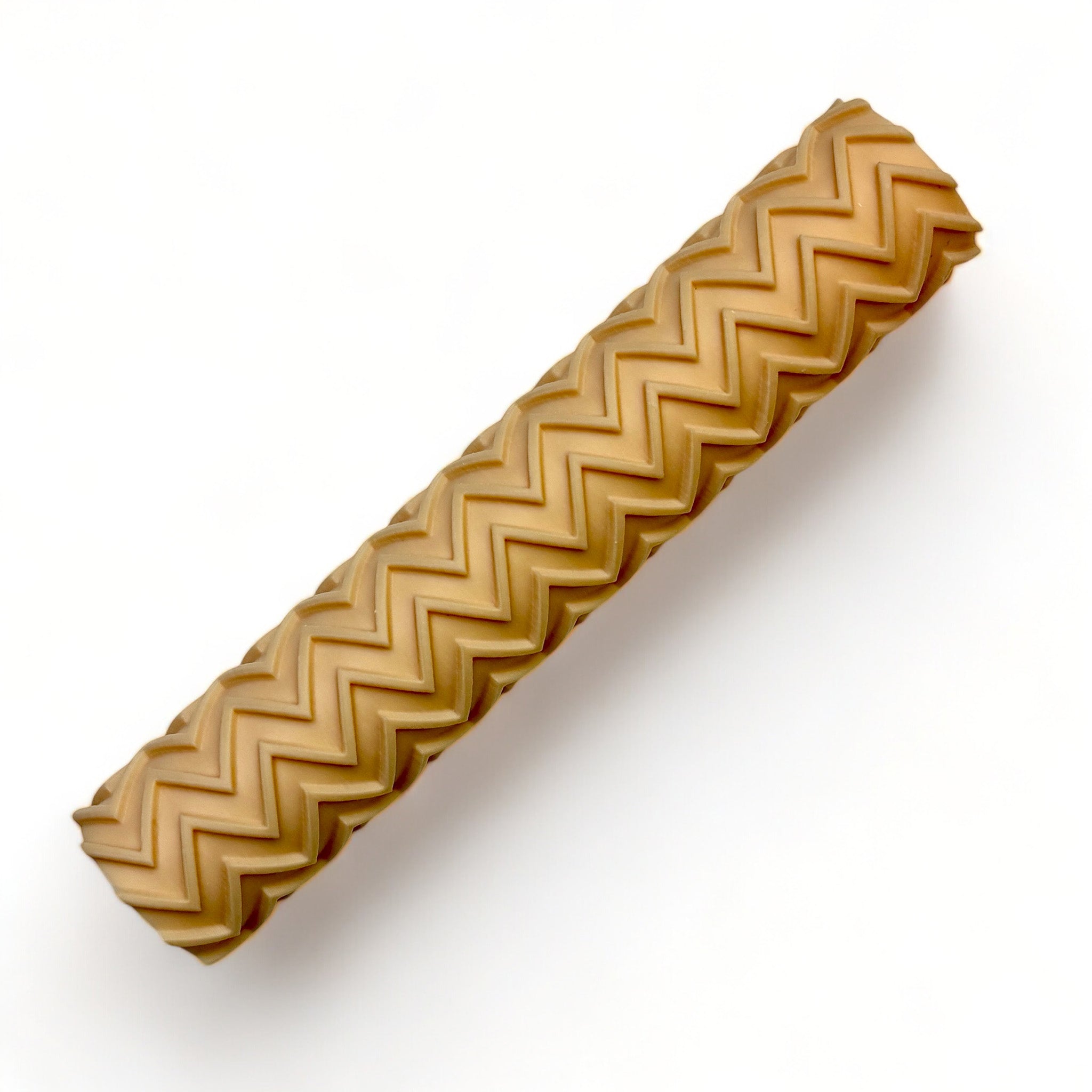 A seamless texture roller featuring a zig zag pattern is against a white background.
