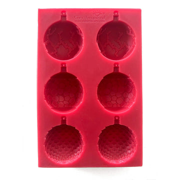 A red silicone mold that features 6 ornate half ornaments that make 3 full ornaments is against a white background.