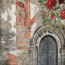 Close-up of a rice paper featuring gorgeous red roses blooming over an arched doorway on a brick wall.