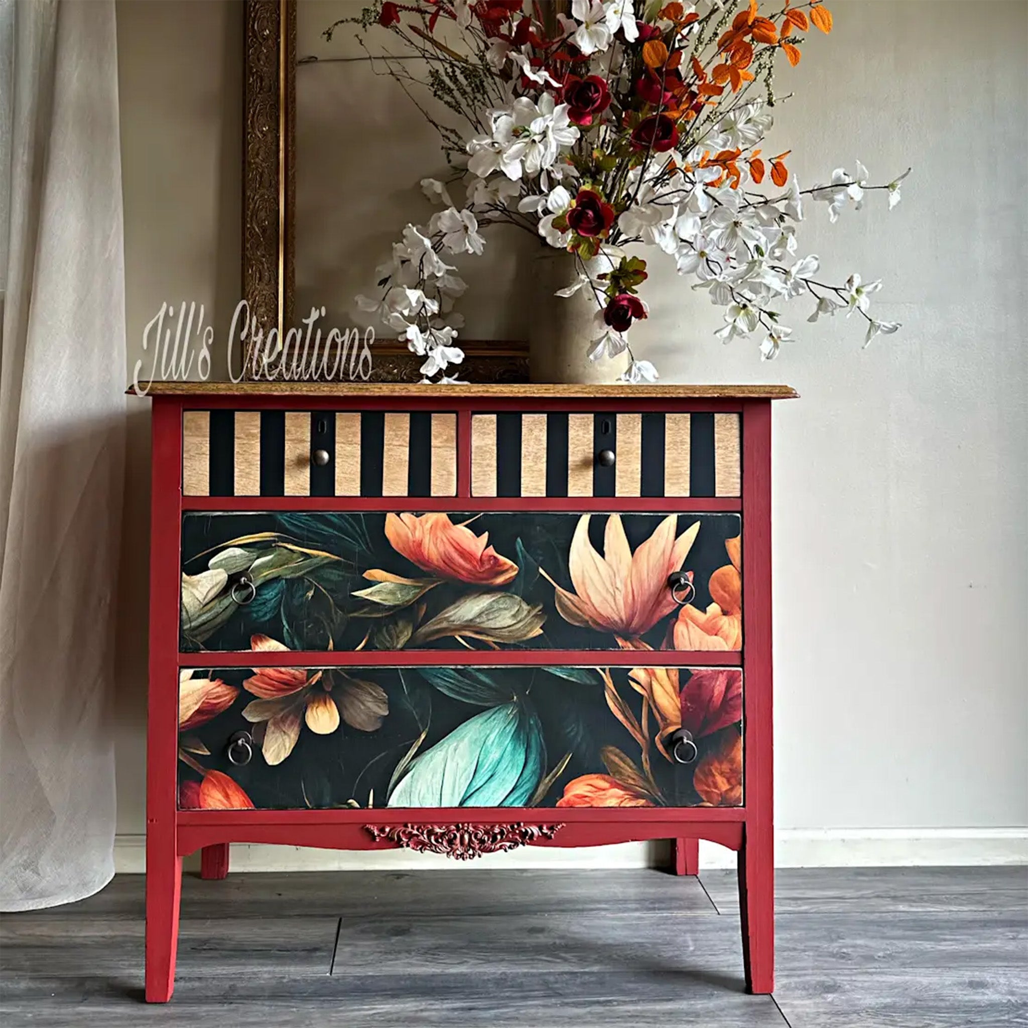 A vintage 4-drawer dresser refurbished by Jill's Creations is painted red and features Mint by Michelle's Autumn decoupage paper on its 2 large bottom drawers.