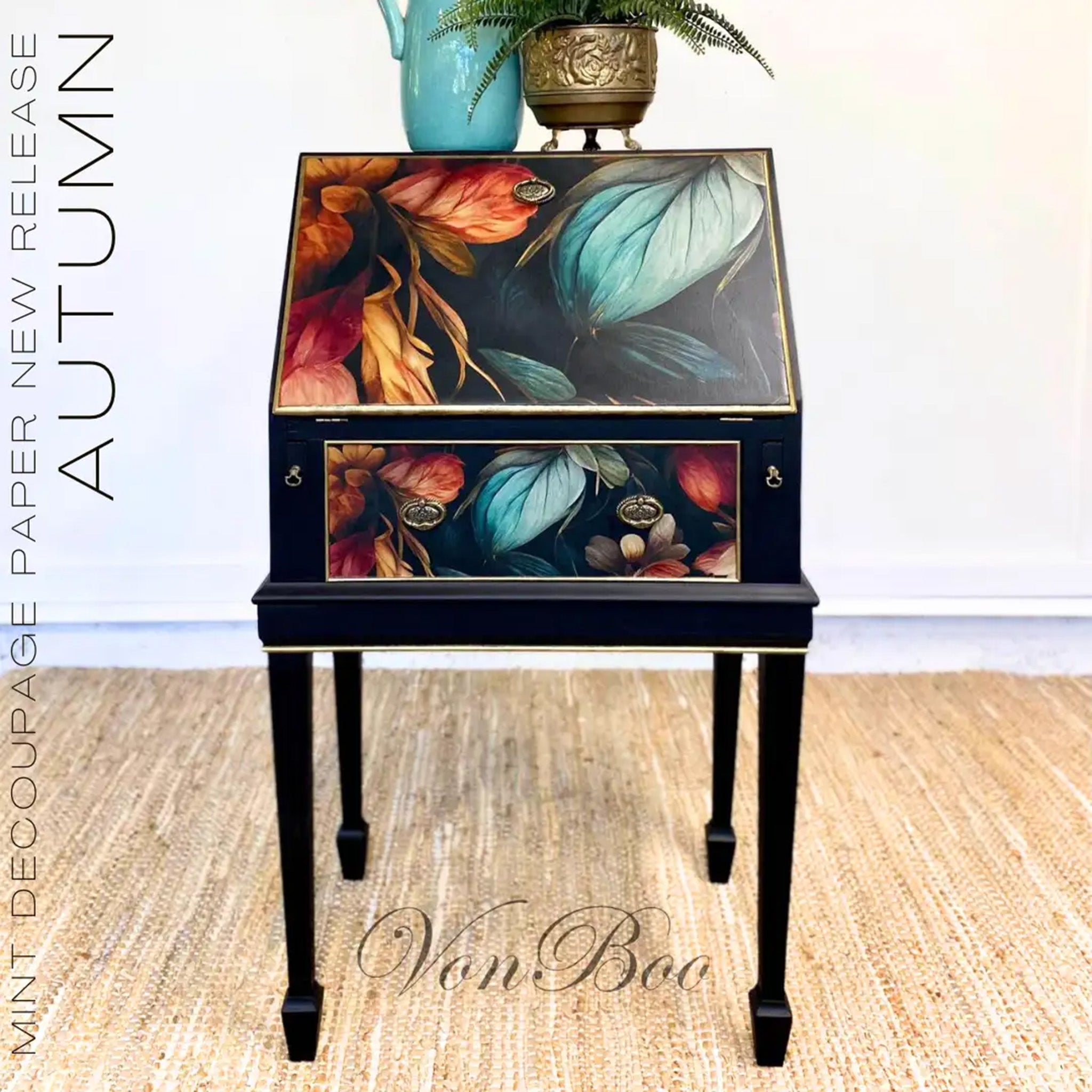 A vintage writing desk refurbished by Von Boo is painted black and features Mint by Michelle's Autumn decoupage paper on its small drawer and flip-down top.