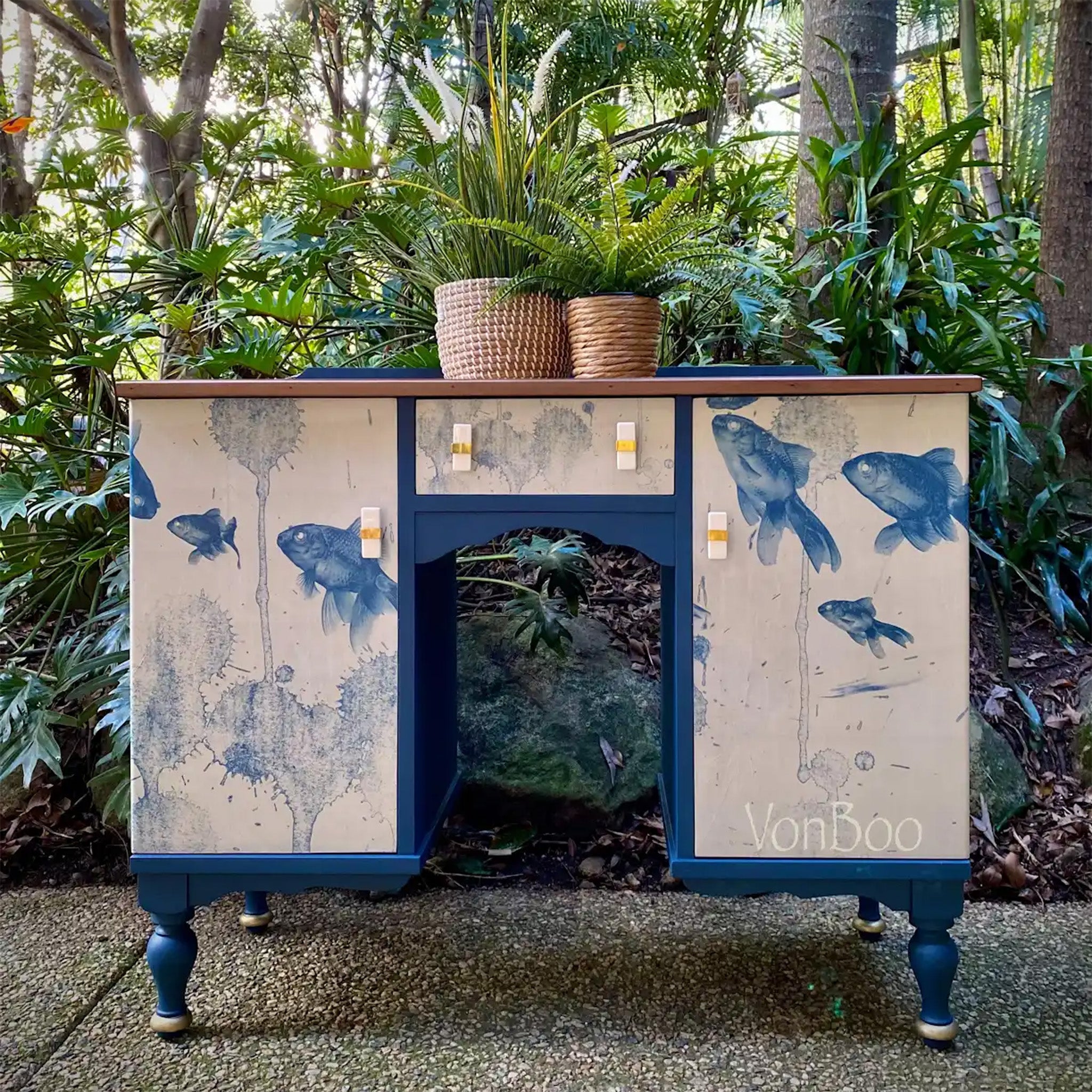 A vintage desk refurbished by Von Boo is painted blue and features Mint by Michelle's Blue Fish decoupage paper on its 2 doors and center drawer.