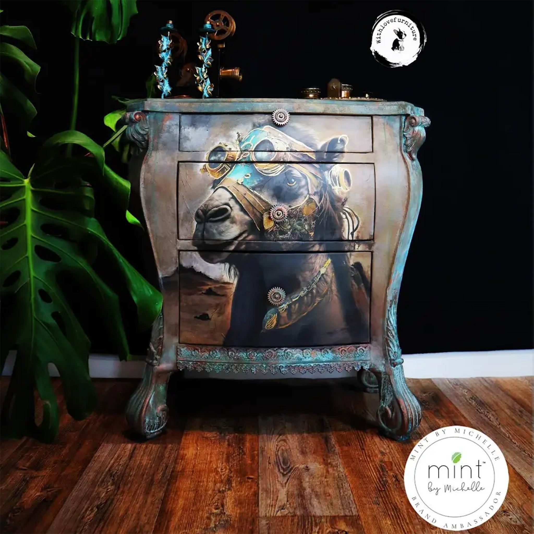 A vintage Bombay dresser refurbished by With Love Furniture is painted faux patina and features Mint by Michelle's Carlito Camel decoupage paper on the front of it.