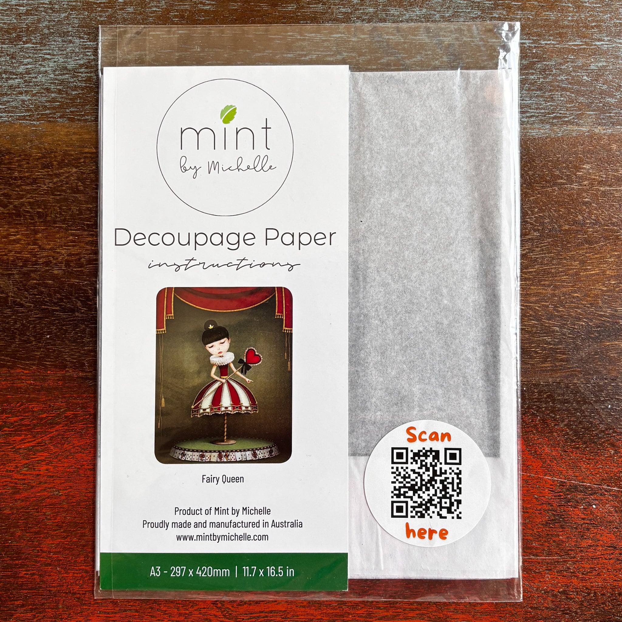 A package of Mint by Michelle's Fairy Queen A3 decoupage paper is against a dark wood background.