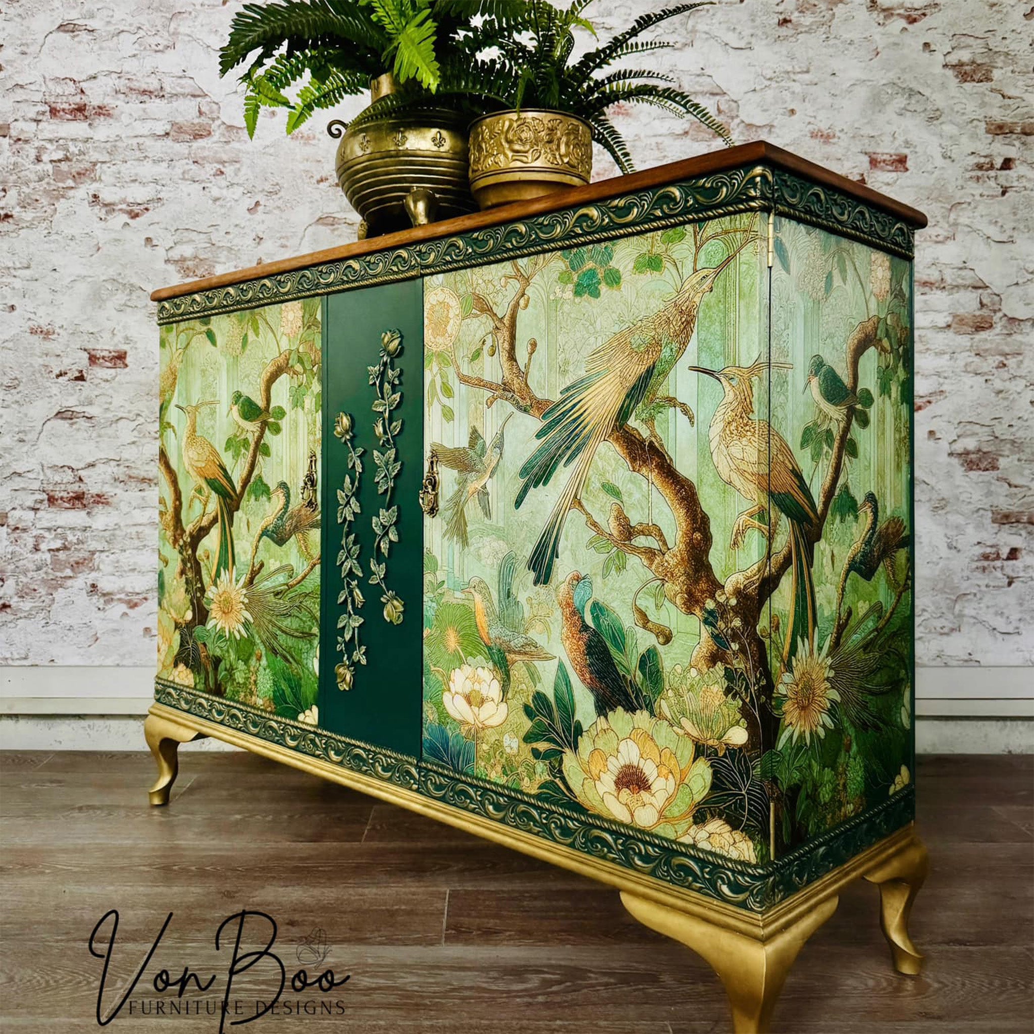 A vintage buffet cabinet refurbished by Von Boo is painted dark green with gold accents and features Mint by Michelle's Green Tapestry decoupage paper on it.