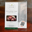 A package of Mint by Michelle's Moody Florals 1 A3 decoupage paper is against a dark wood background.