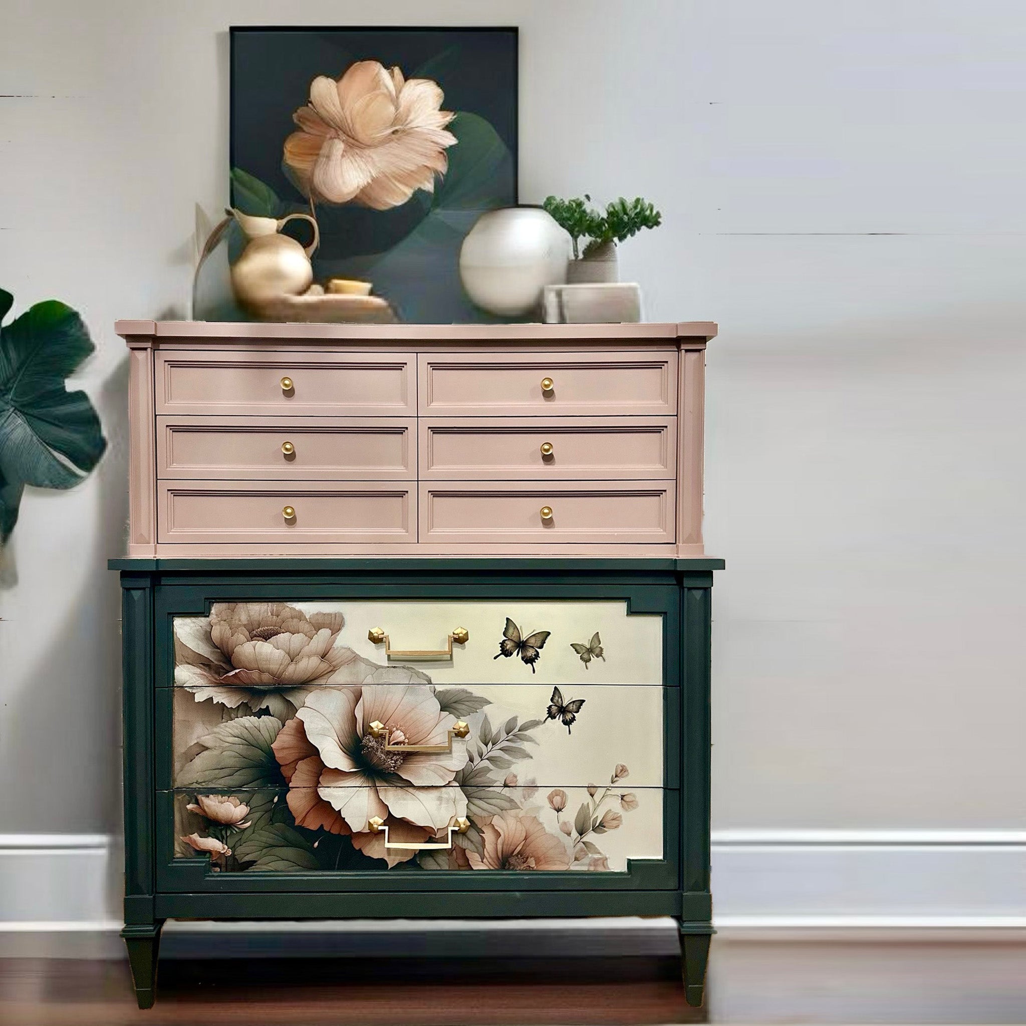 A vintage 9-drawer chest dresser is painted a soft rose pink on its top half and dark hunter green on the bottom half and features Mint by Michelle's Peach Petals decoupage paper on the bottom 3 drawers.