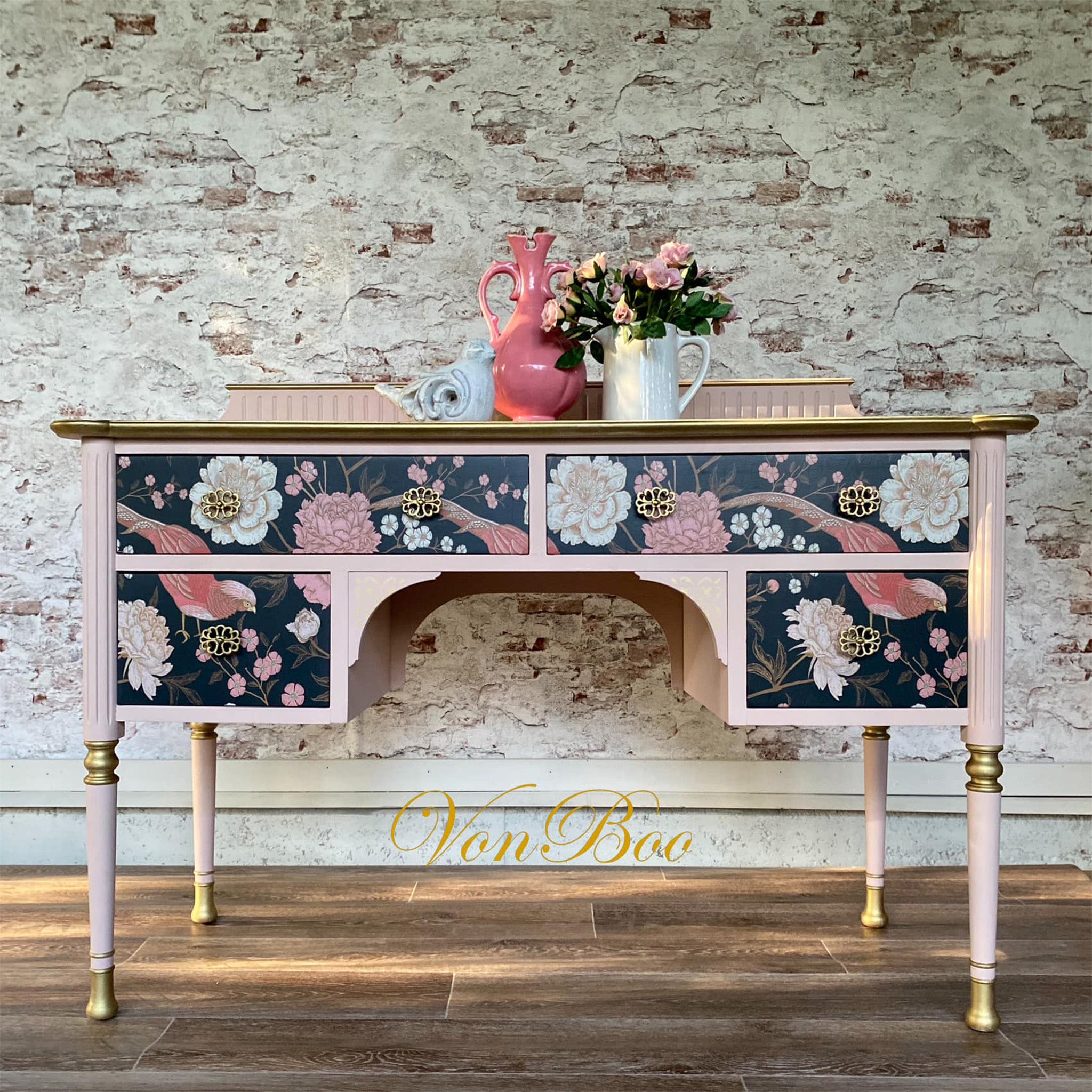 A vintage desk refurbished by Von Boo is painted pale pink with gold accents and features Mint by Michelle's Pheasant decoupage paper on its 4 drawers.