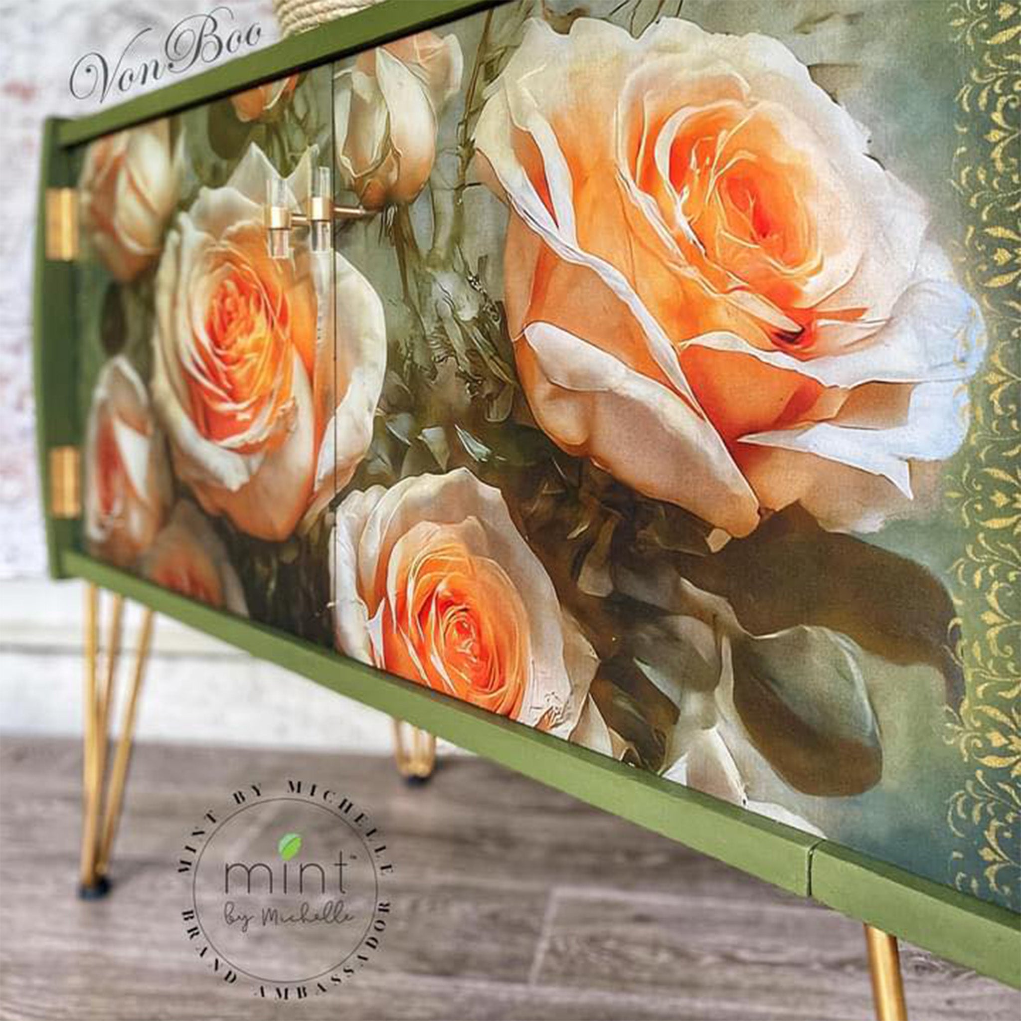 Close-up of a vintage console table with storge refurbished by Von Boo is painted avocado green with gold accents and features Mint by Michelle's Roses on High decoupage paper on its 2 doors.