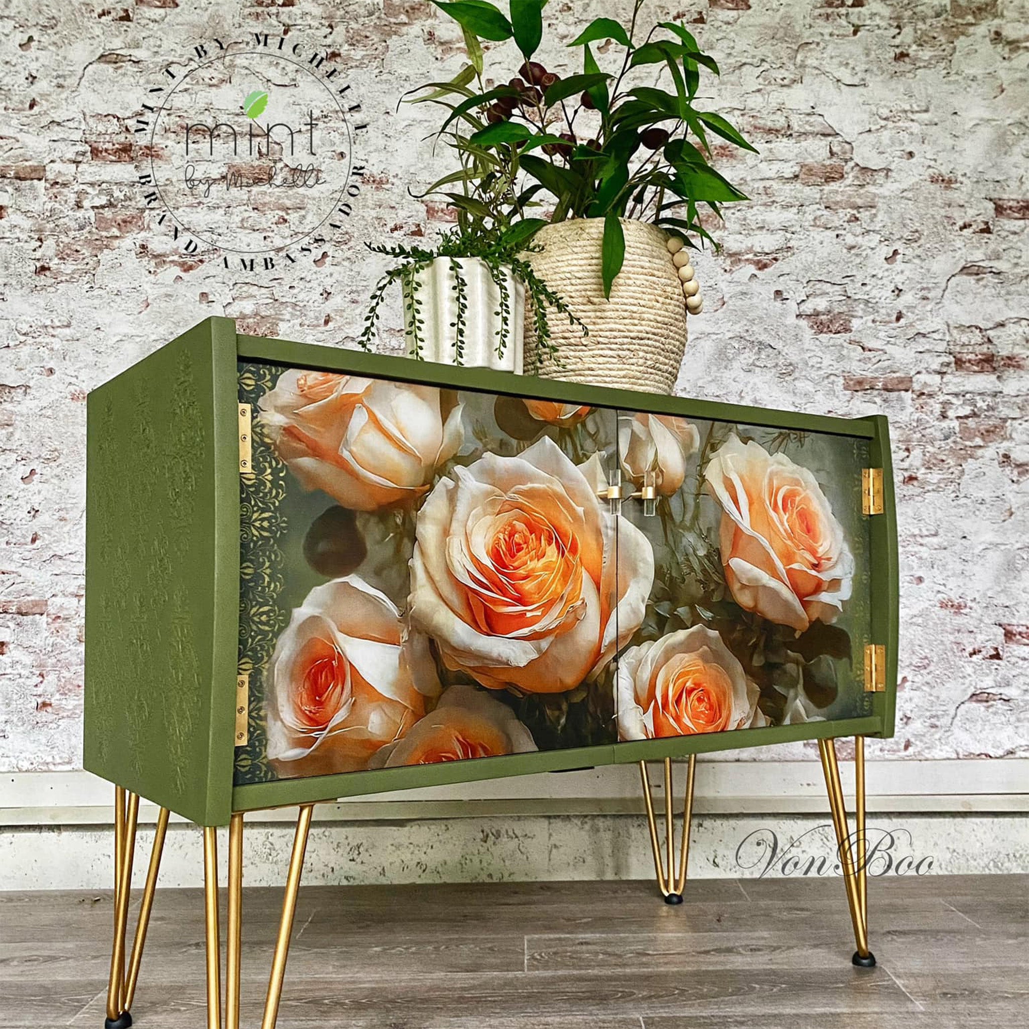 A vintage console table with storge refurbished by Von Boo is painted avocado green with gold accents and features Mint by Michelle's Roses on High decoupage paper on its 2 doors.