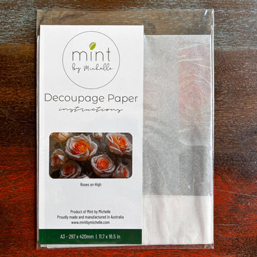 A package of Mint by Michelle's Roses on High A3 decoupage paper is against a dark wood background.
