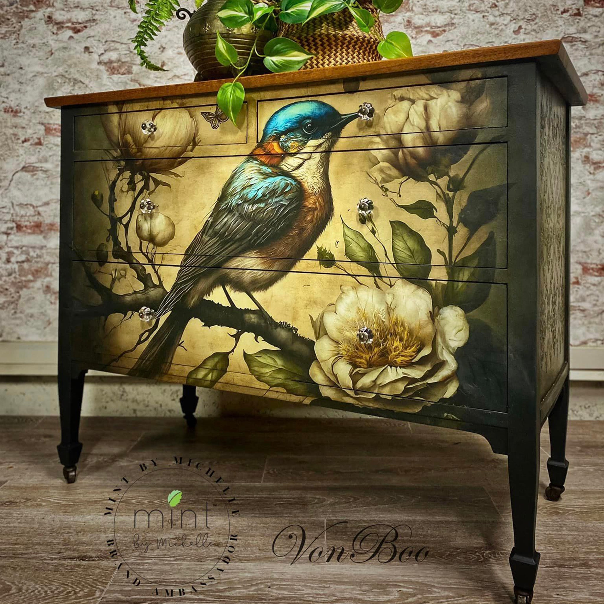 A vintage 4-drawer dresser refurbished by Von Boo is painted black with a natural wood top and features Mint by Michelle's Sweet Bird in Blue decoupage paper on the front.