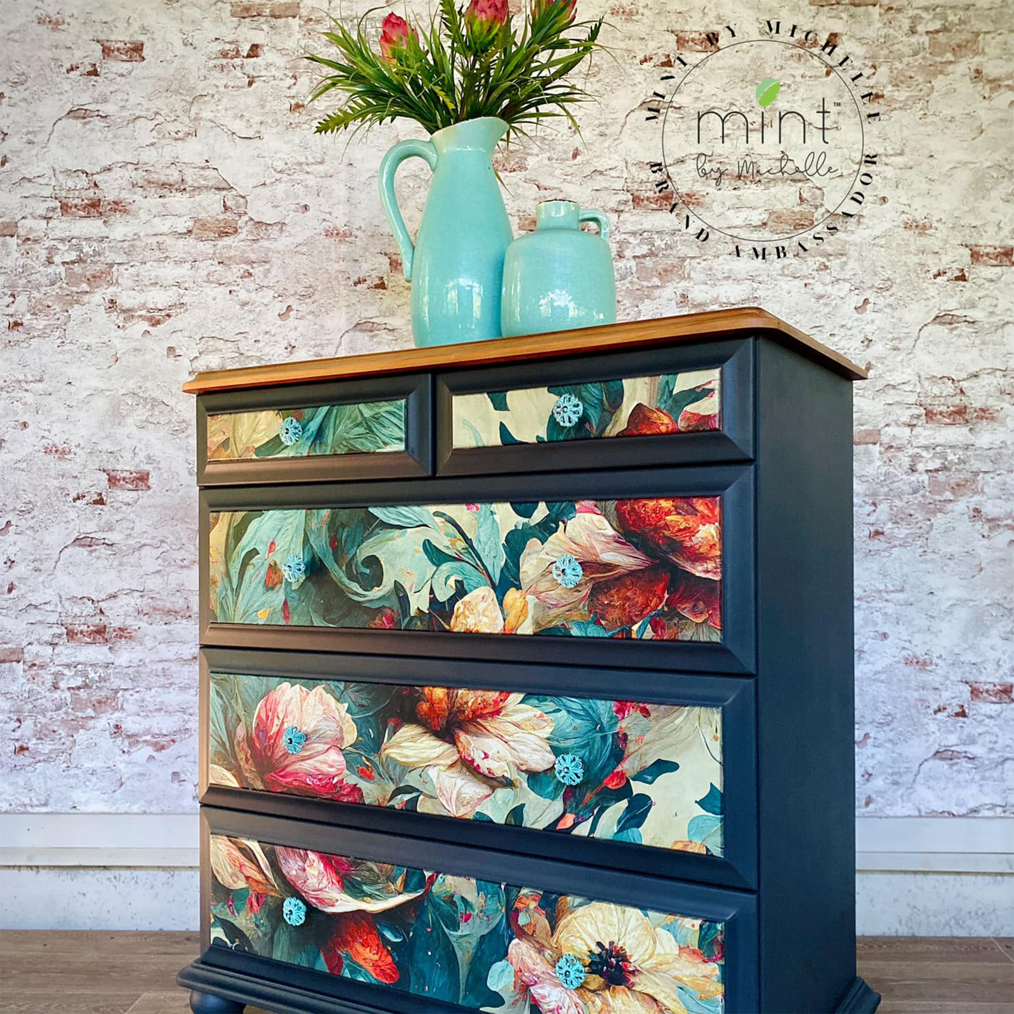 A vintage 5-drawer chest dresser is painted dark blue and features Mint by Michelle's Wave of Florals decoupage paper on the drawers.