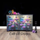 A 6-drawer dresser refurbished by Calle's ReDesign's is painted dark grey and features Whimsykek's Purple Poppies tissue paper on its drawers.