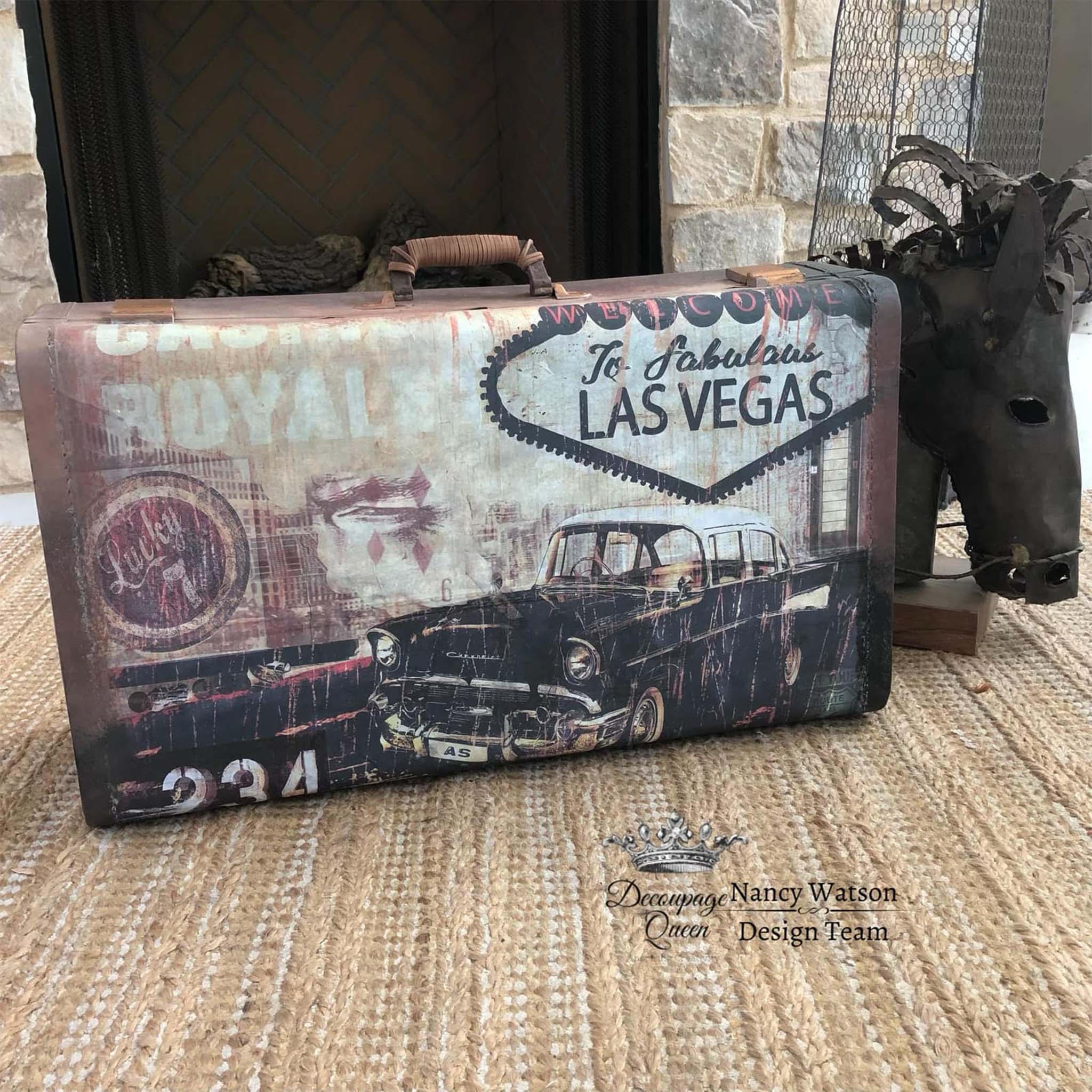 A vintage suitcase features Decoupage Queen's Fabulous Las Vegas rice paper on it.