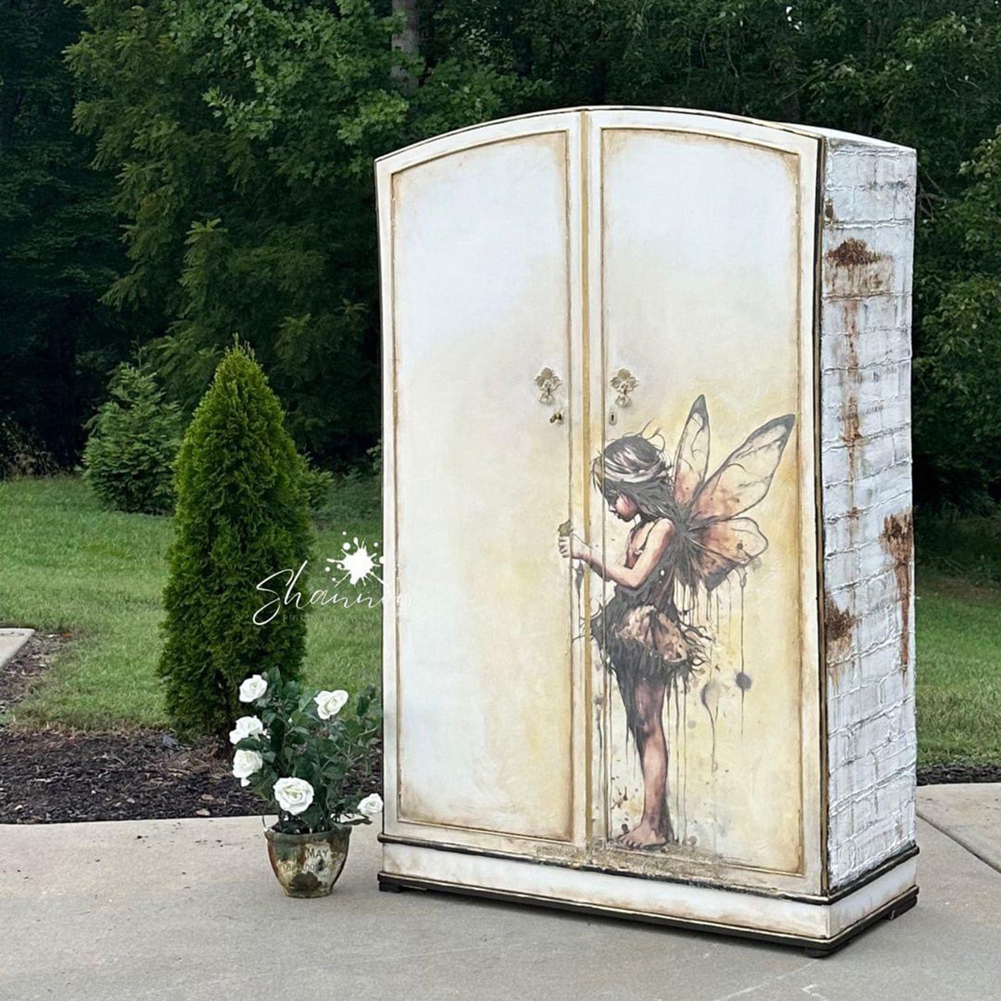 A large armoire is painted rustic white and features Decoupage Queen's Andy Skinner Maia Fairy Angel on the doors.