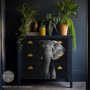 A dresser is painted dark navy blue and features ReDesign with Prima's Shadows of Wisdom A1 fiber paper on its 3 drawers.