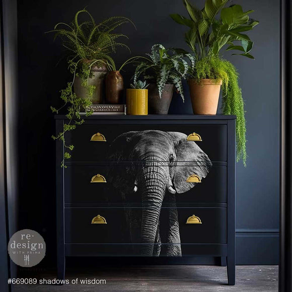 A dresser is painted dark navy blue and features ReDesign with Prima's Shadows of Wisdom A1 fiber paper on its 3 drawers.