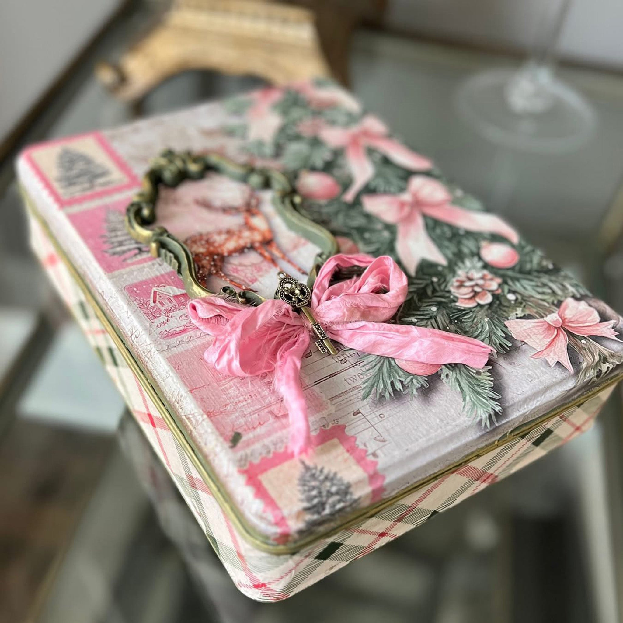 A small tin box features Decoupage Queen's Pink Trimmings rice paper on the lid along with a real pink ribbon and a gold painted silicone mold ornate frame.