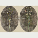 Rice paper featuring 2 oval images of ornate seamstress scissors. 