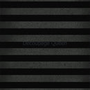 Close-up of a rice paper that features a bold stripe pattern of solid black and grey speckled stripes.