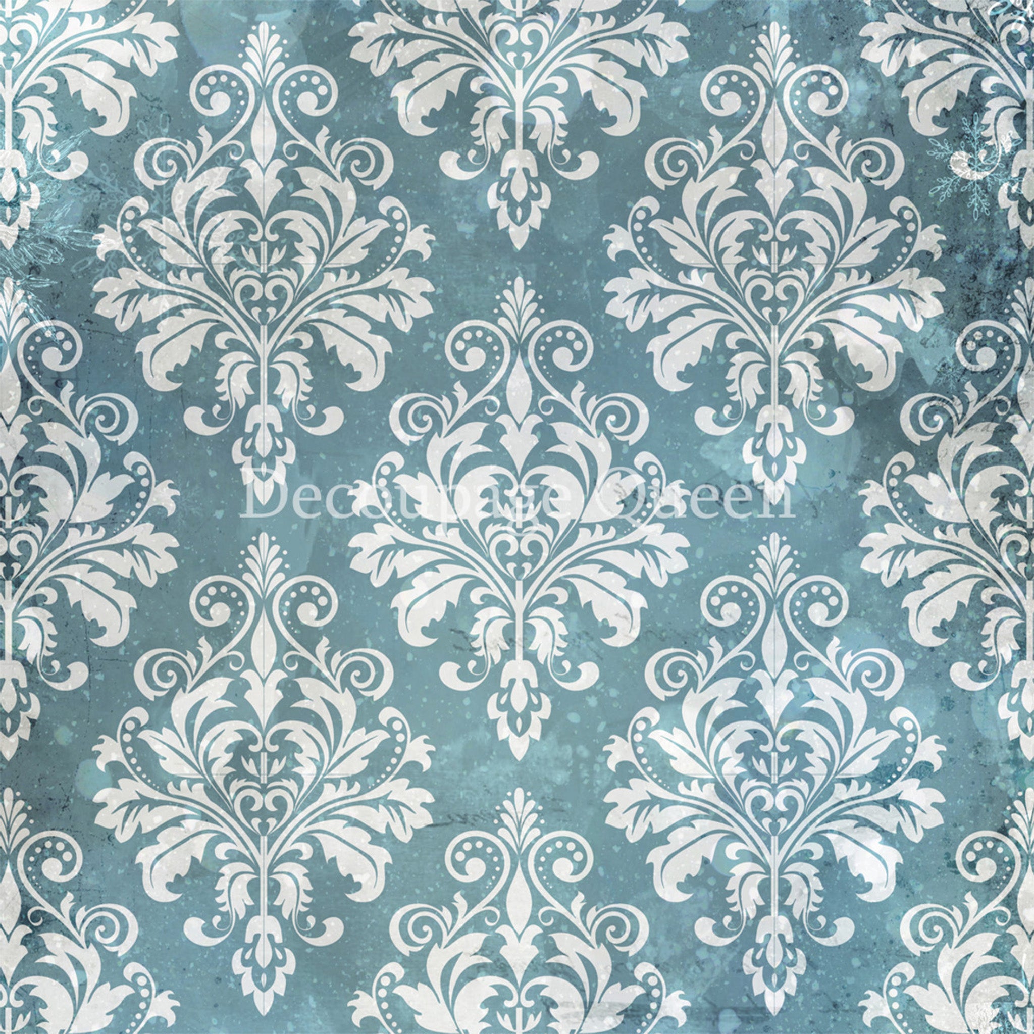 Close-up of a rice paper design that features a soft white flourish damask pattern against a wintery blue background. 