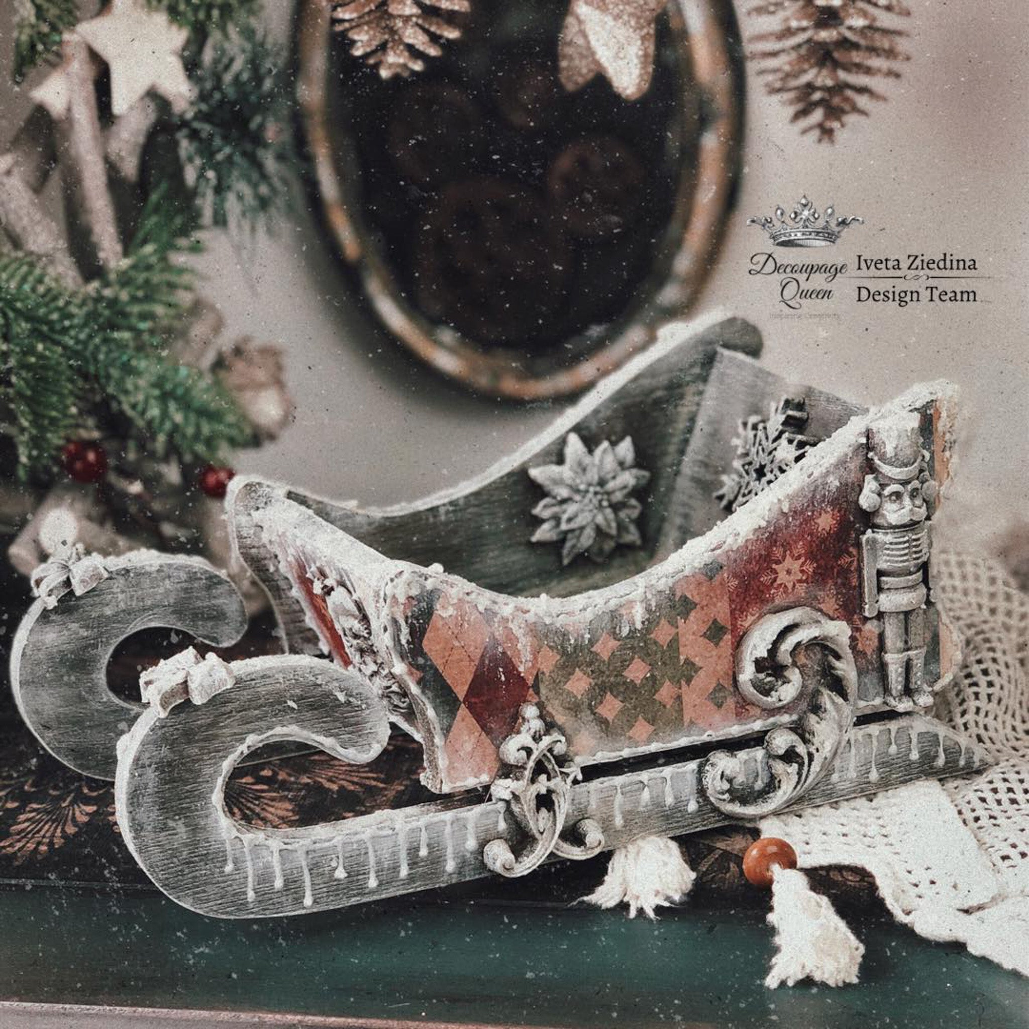 A small wood sleigh created by Iveta Ziedina Design Team features Decoupage Queen's Holiday Wrapping rice paper on it.