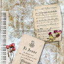 Close-up of a rice paper featuring vintage sheet music, pink roses, and a piano keys against a distressed background.