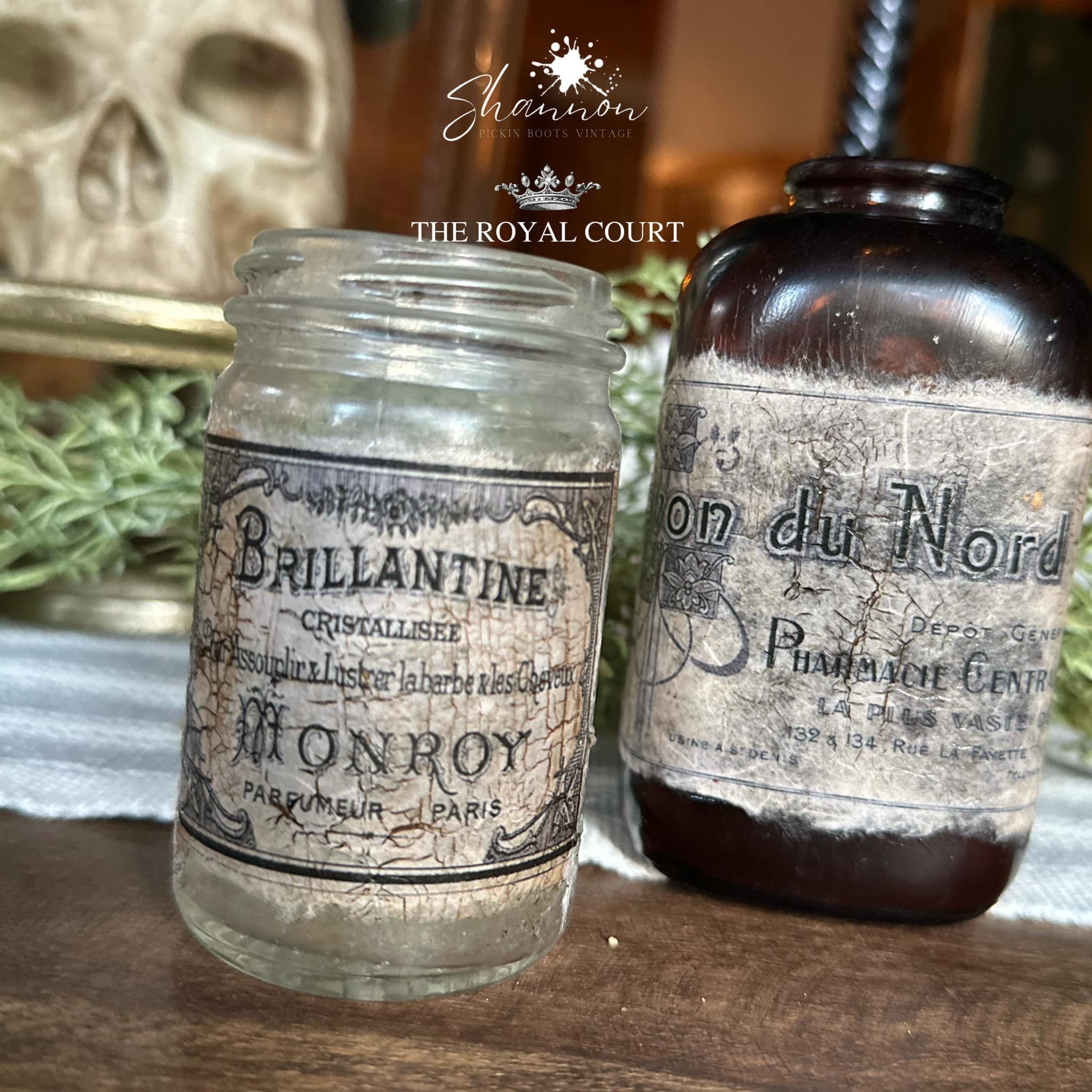 Two glass jars feature Decoupage Queen's Perfume Labels rice paper on them.