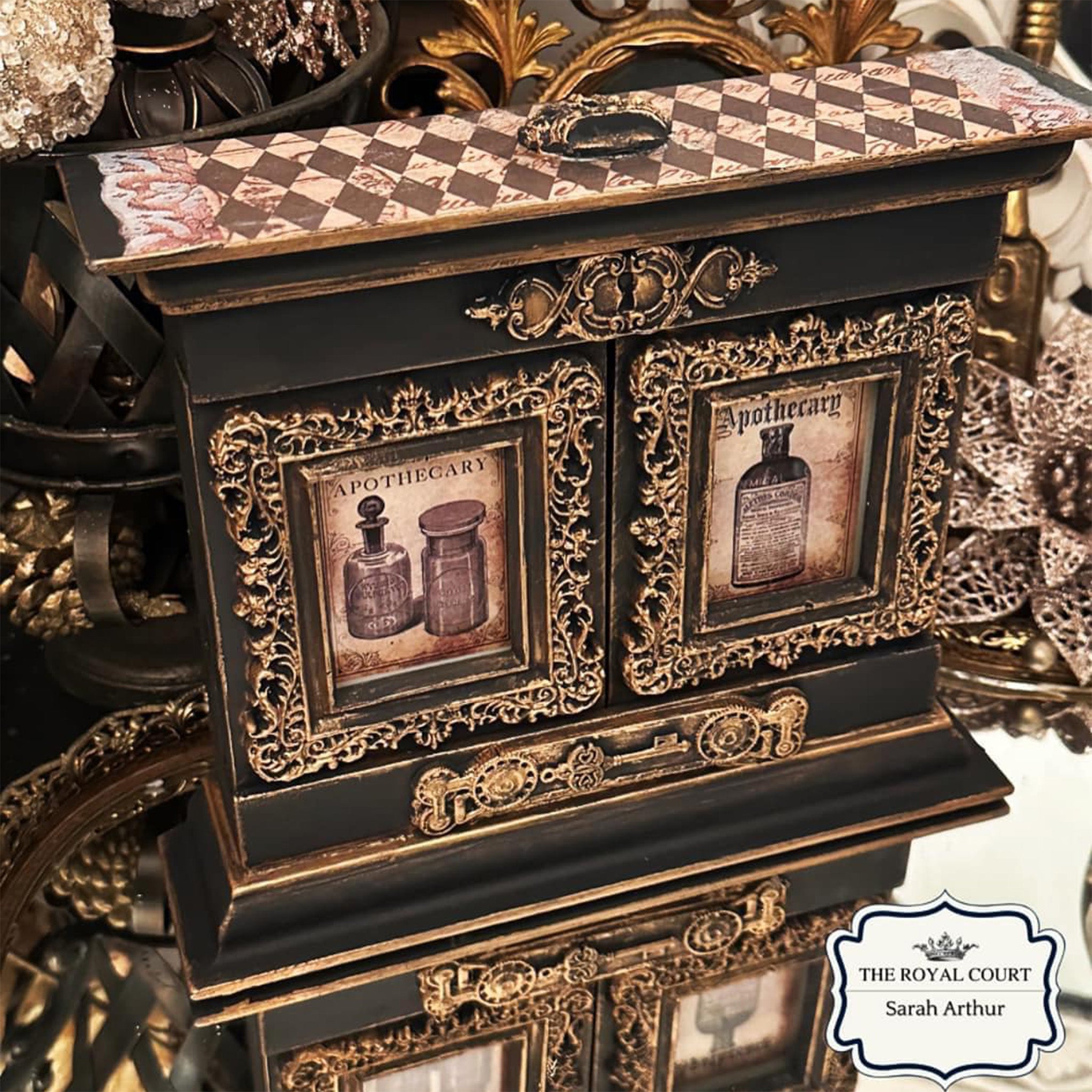 A decor piece created by Sarah Arthur is painted black with antique gold details and features Decoupage Queen's Sheila's Black Harlequin rice paper on the top.