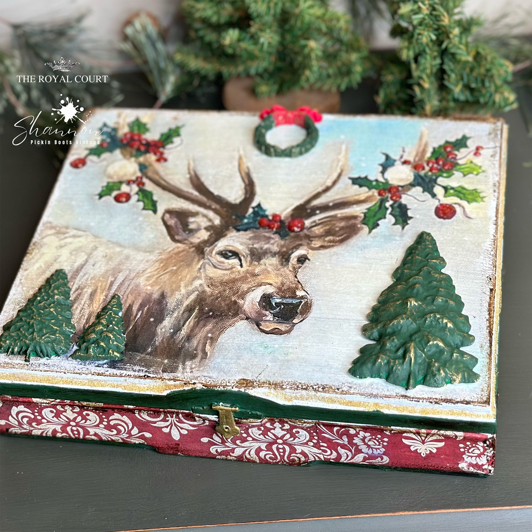 A shallow wood craft box features Decoupage Queen's Snowy Elk rice paper on the lid and Decoupage Queen's Red Christmas Damask rice paper on the bottom.