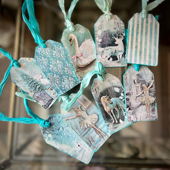Ten gift tags with blue ribbons feature Decoupage Queen's Winter Minis A4 rice paper on them.