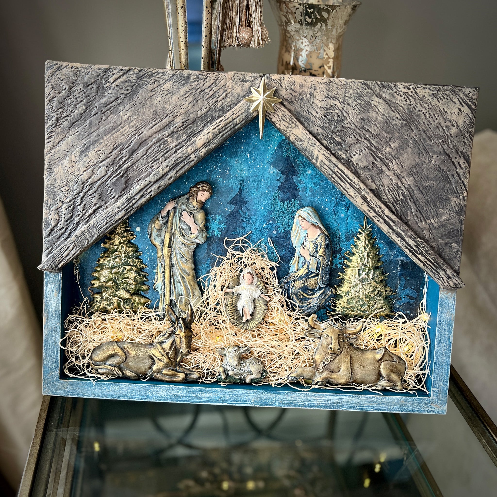 A wood photo frame features colorful castings created from Decoupage Queen's Holy Family silicone mold to create a nativity scene.