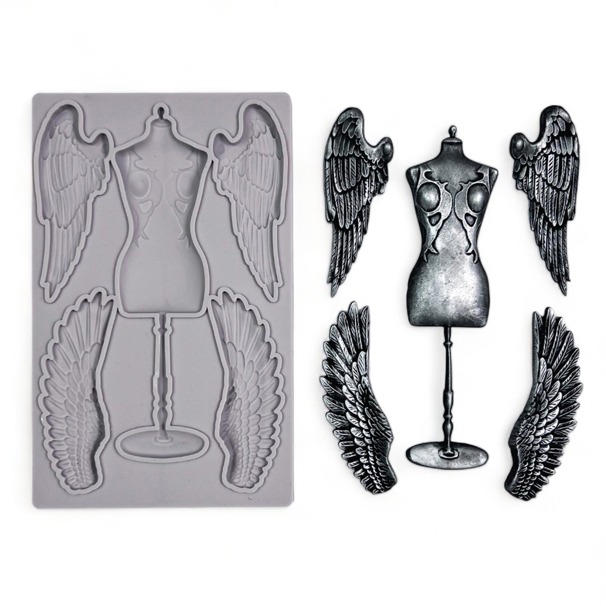 A grey silicone mold and silver colored castings of a seamstress dress form and 2 sets of angel wings are against a white background.