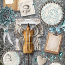 Close-up of a rice paper that features vintage dressing room decor and a dress form with wings against a damask background.