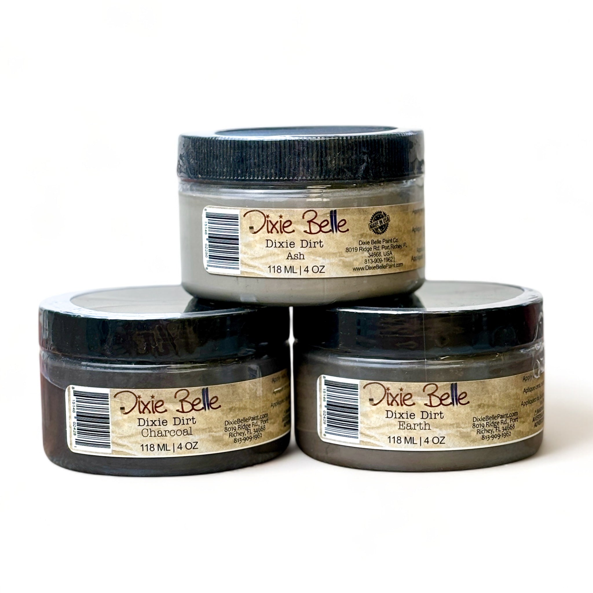 Three 4oz containers of Dixie Belle Paint Company's Dixie Dirt in Ash, Earth, and Charcoal are shown against a white background. These are loose pigments used to create shadowing and dimension to any furniture project.