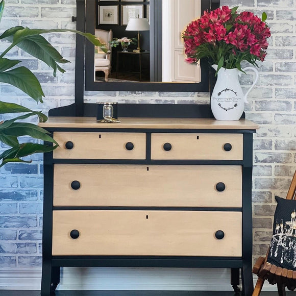 A 4-drawer dresser with an attached mirror has natural wood and features Dixie Belle's Anchor Silk All-In-One Mineral Paint.