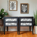 Two vintage 2-drawer night stands refurbished by Vintage Revitalized by Tina Brown feature Dixie Belle's Anchor Silk All-In-One Mineral Paint and a black and white design on the drawers.