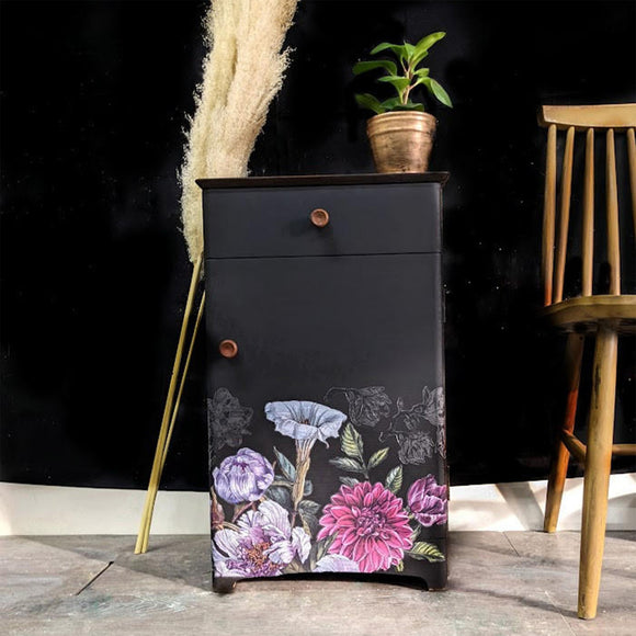 A vintage side table with a drawer and cubby door features Dixie Belle's Anchor Silk All-In-One Mineral Paint and a floral rub-on transfer.